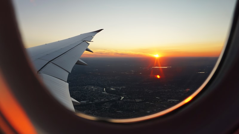 Airplane wing above clouds during a budget flight