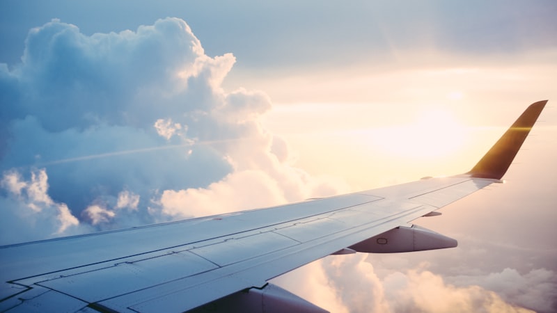 Airplane flying through bright sky